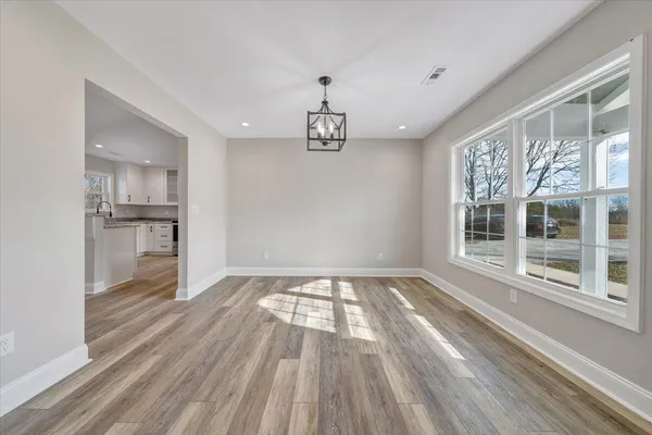 a view of kitchen with wooden floor electronic appliances and window