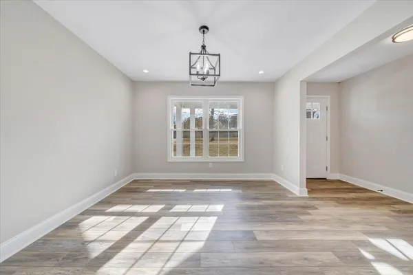 a kitchen with stainless steel appliances white cabinets and a refrigerator