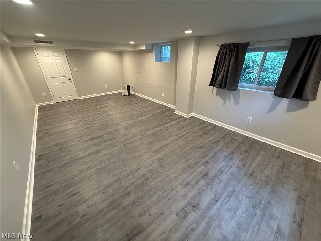 1087 Krumroy Road Akron, OH 44306 - Photo 18 of 23 Spacious room featuring wood-finish flooring, recessed lighting, and light gray walls with white trim