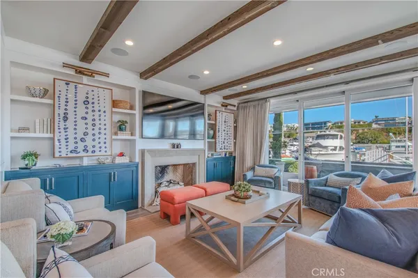 a living room with furniture a fireplace and a table