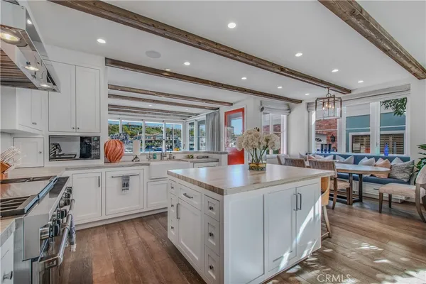 a kitchen with appliances a sink and cabinets