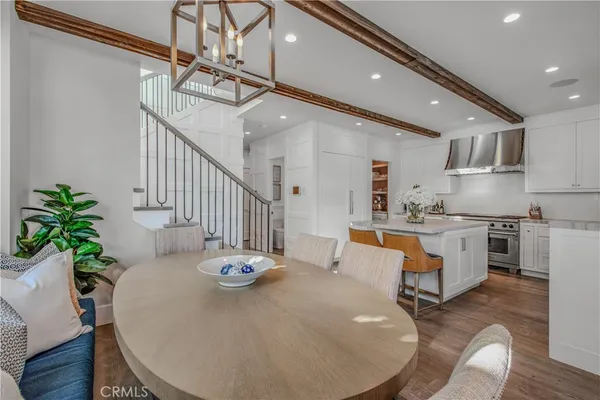 a dining room with furniture window and wooden floor