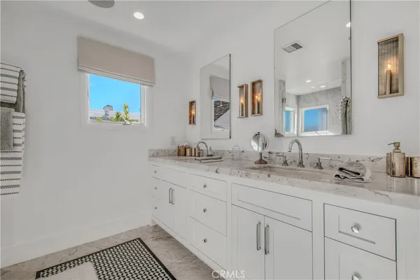 a living room with furniture a flat screen tv and a window