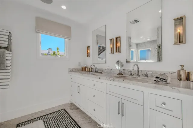 a living room with furniture a flat screen tv and a window