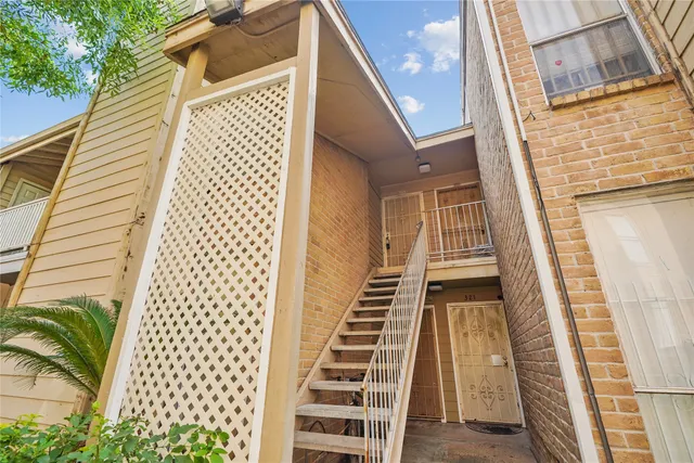 a view of outdoor space with deck and white walls