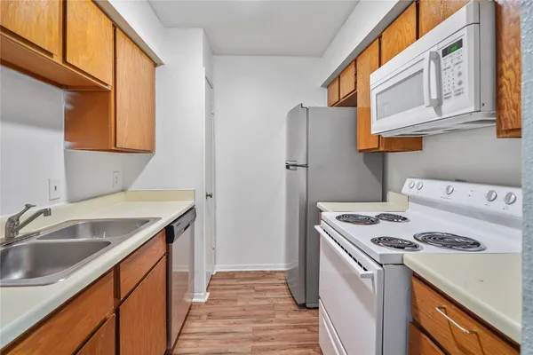 a kitchen with a sink a stove and a refrigerator