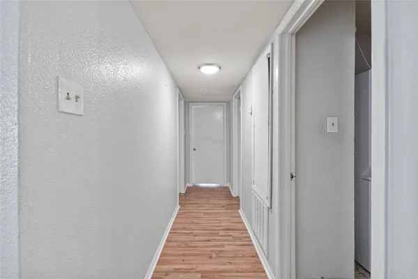 a view of a hallway with a white door