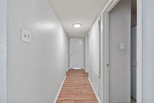 a view of a hallway with a white door