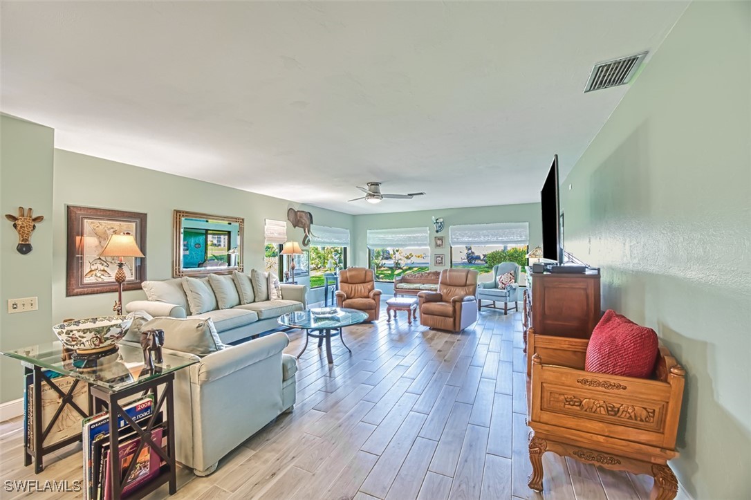 1683 Bent Tree Circle Fort Myers, FL 33907 - Photo 11 of 48 a living room with furniture and a flat screen tv