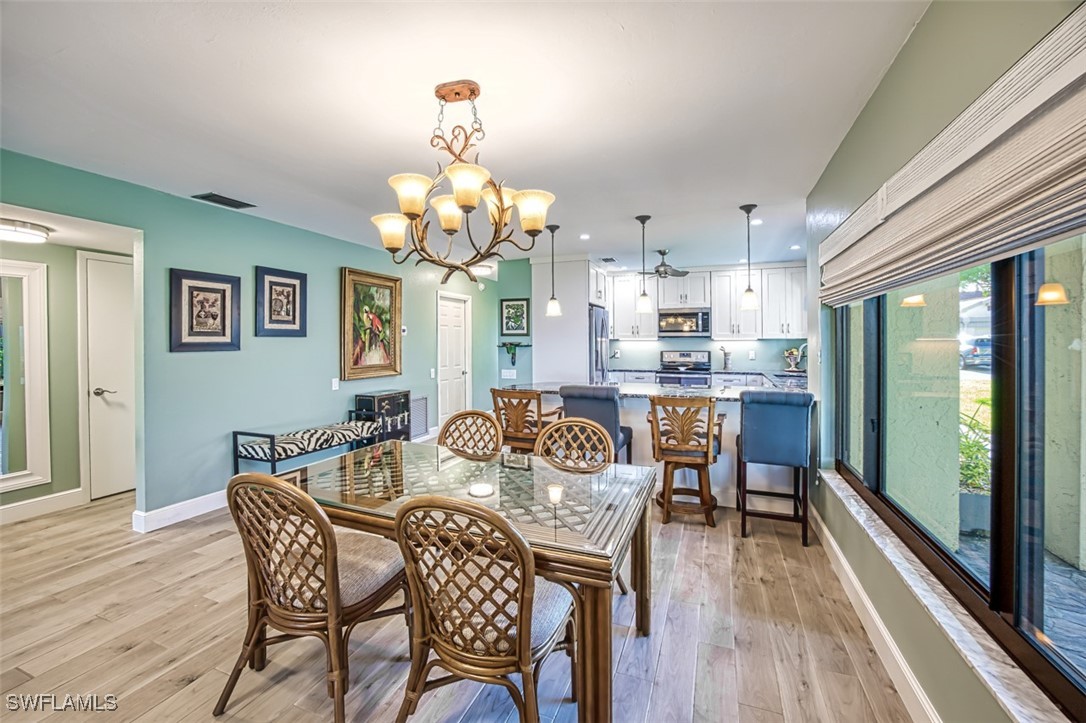 1683 Bent Tree Circle Fort Myers, FL 33907 - Photo 12 of 48 a view of a dining room with furniture wooden floor and chandelier