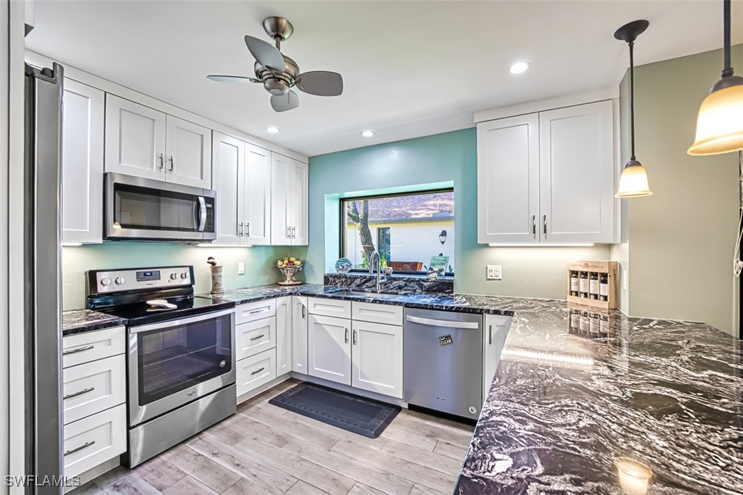1683 Bent Tree Circle Fort Myers, FL 33907 - Photo 17 of 48 a kitchen with granite countertop appliances cabinets and a counter space