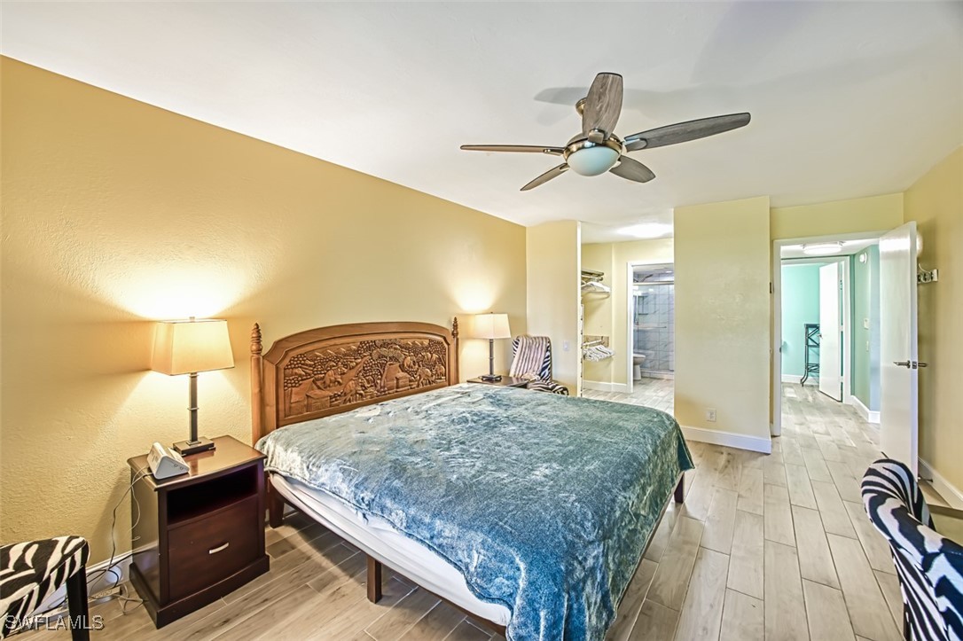 1683 Bent Tree Circle Fort Myers, FL 33907 - Photo 24 of 48 a bedroom with a bed and wooden floor