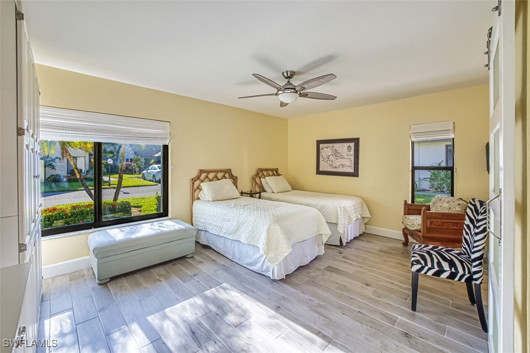1683 Bent Tree Circle Fort Myers, FL 33907 - Photo 30 of 48 a bedroom with a bed and a chandelier