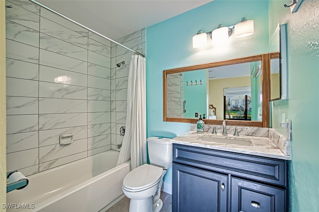 1683 Bent Tree Circle Fort Myers, FL 33907 - Photo 32 of 48 a bathroom with a sink a toilet and shower