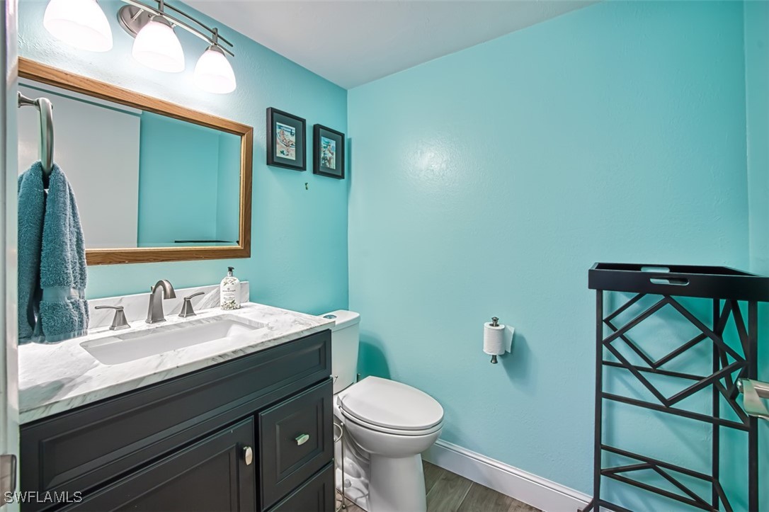 1683 Bent Tree Circle Fort Myers, FL 33907 - Photo 35 of 48 a bathroom with a sink a toilet and mirror