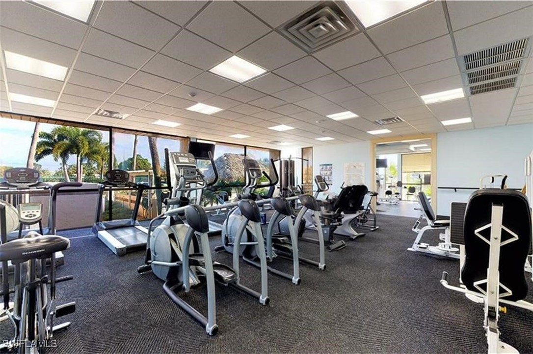 1683 Bent Tree Circle Fort Myers, FL 33907 - Photo 42 of 48 a room with lots of chairs a large window and a projector
