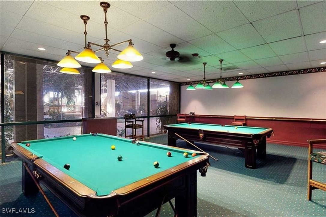 1683 Bent Tree Circle Fort Myers, FL 33907 - Photo 43 of 48 a room with pool table and a chandelier