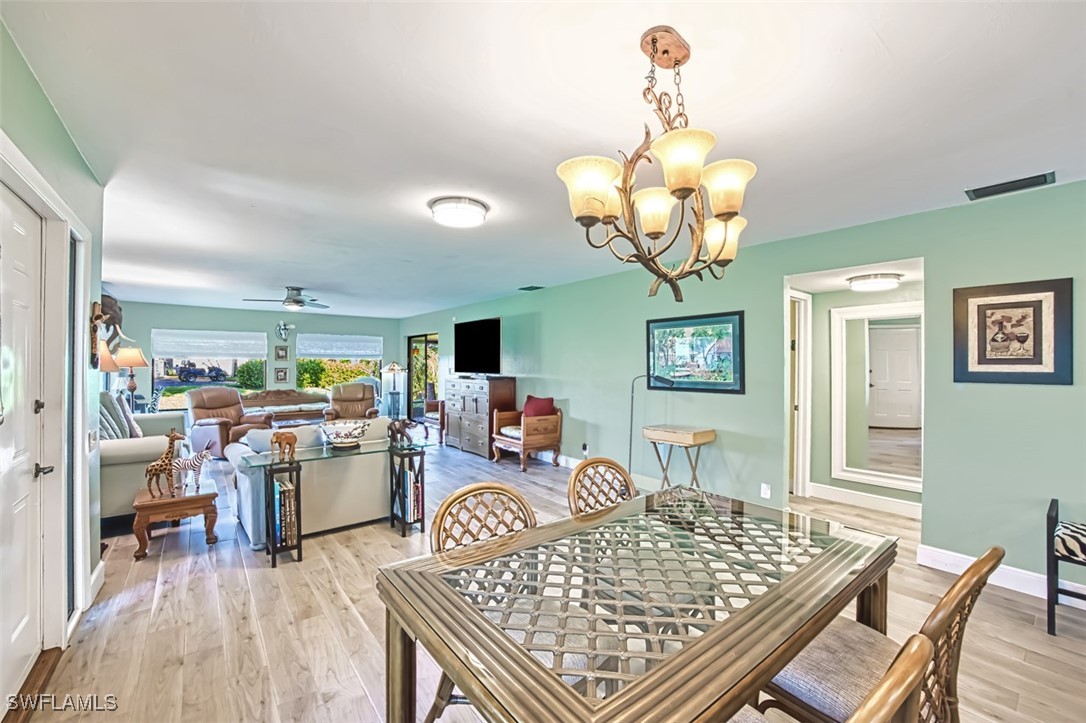 1683 Bent Tree Circle Fort Myers, FL 33907 - Photo 9 of 48 a living room with dining table and a chandelier