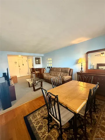 a living room with furniture a rug and a lamp