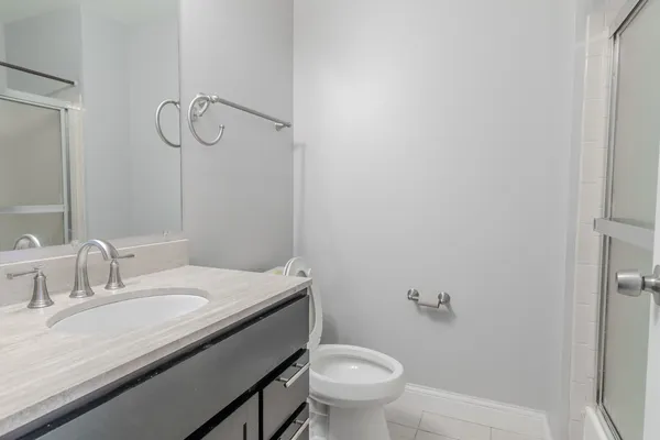 a bathroom with a glass shower door