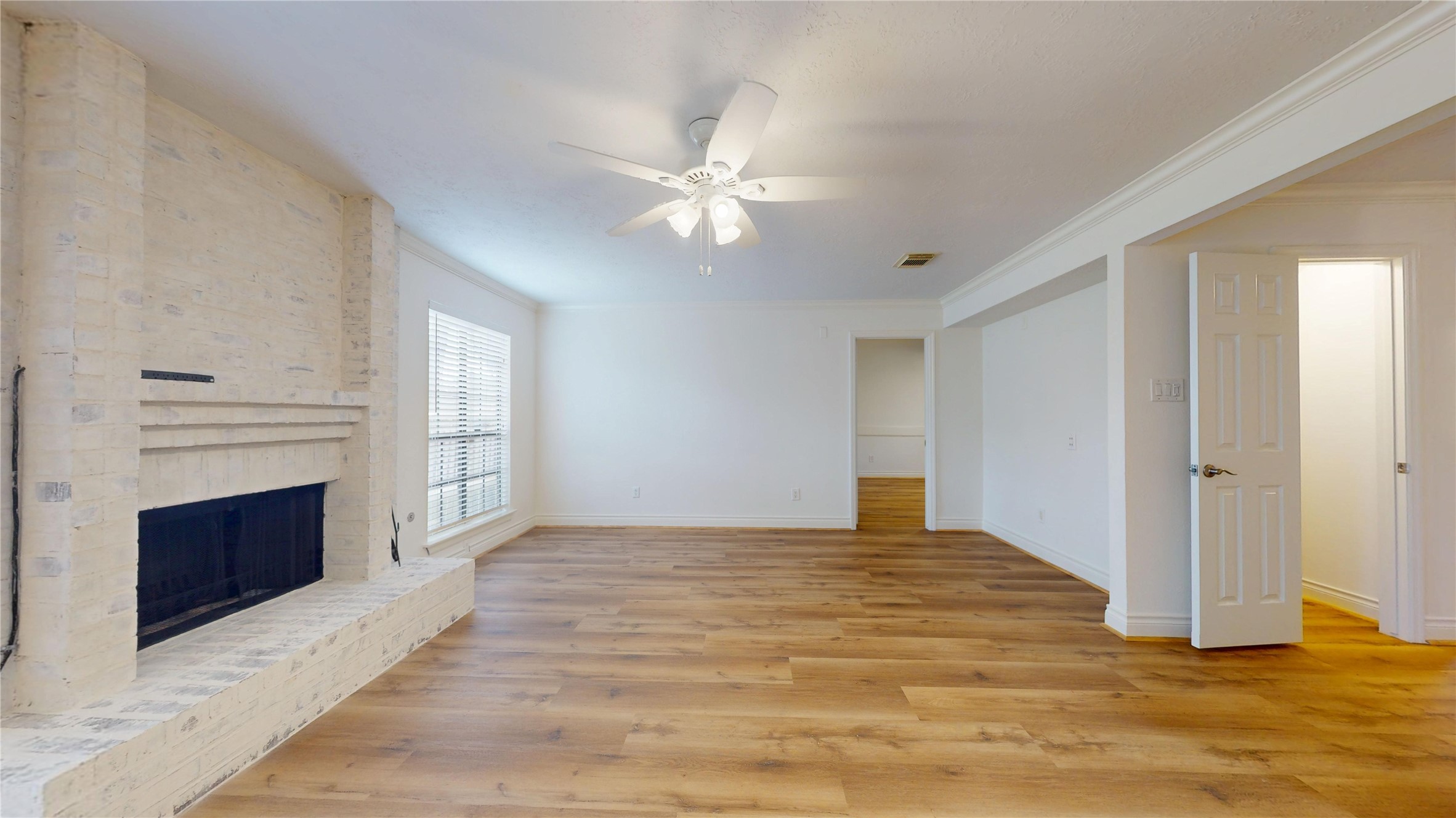 Generous proportions provide plenty of room for multiple seating arrangements, while the open feel creates an easy flow into the adjoining spaces. A welcoming focal point adds character and charm, making this a wonderful gathering space.
