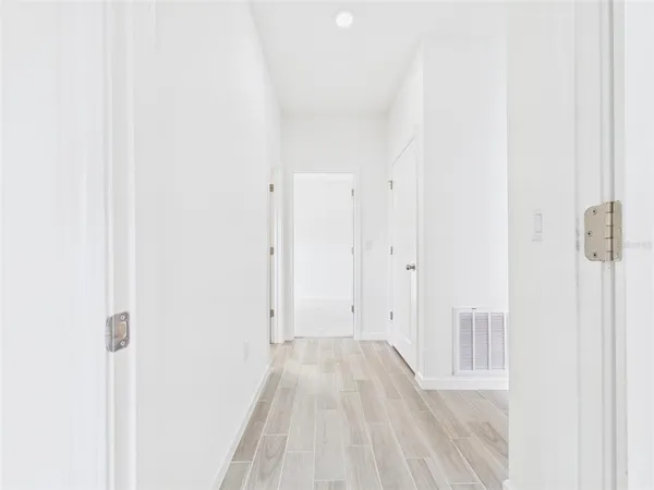 a view of a room with wooden floor