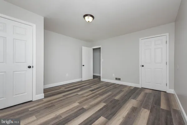 a view of a room with wooden floor
