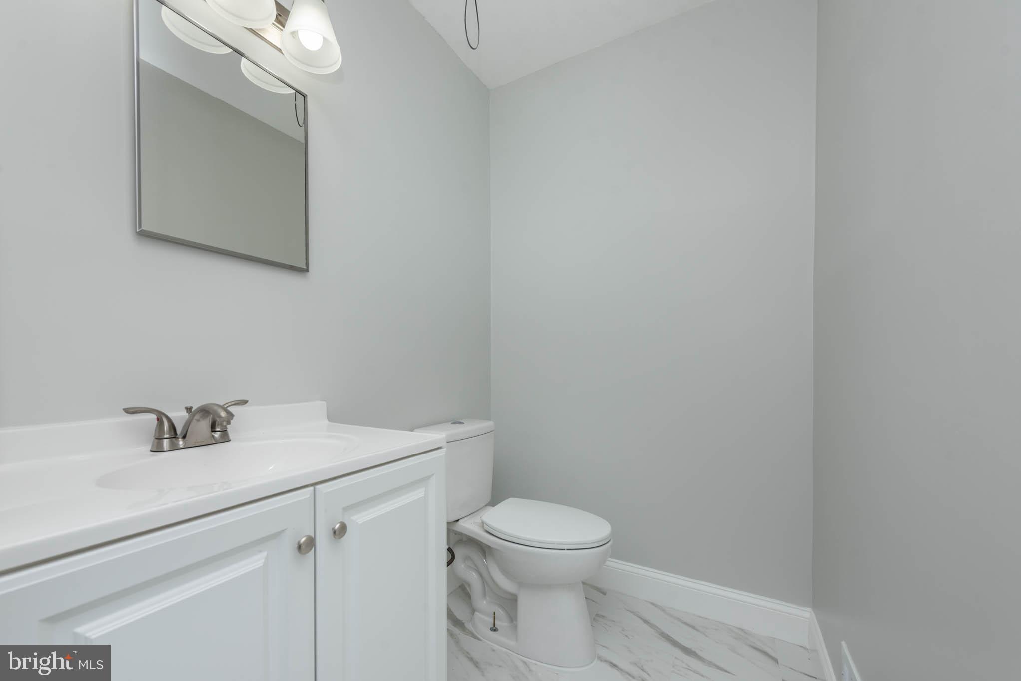 5611 Force Road Baltimore, MD 21206 - Photo 12 of 21 a bathroom with a sink a toilet and mirror