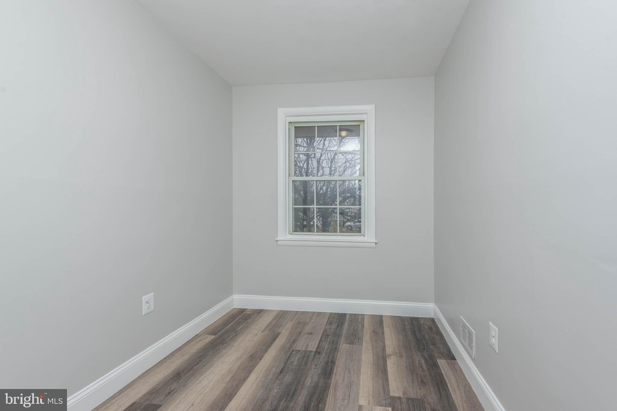 5611 Force Road Baltimore, MD 21206 - Photo 15 of 21 a view of an empty room with wooden floor and a window