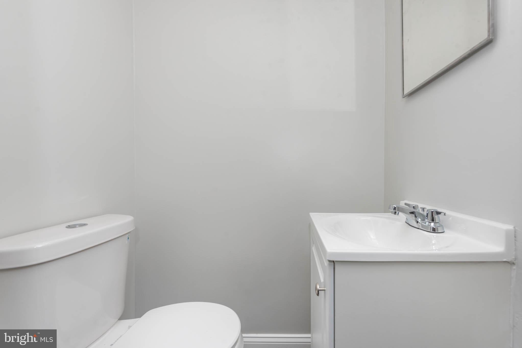 5611 Force Road Baltimore, MD 21206 - Photo 8 of 21 a white toilet sitting next to a white sink