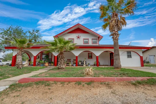 a front view of house with yard and swimming pool