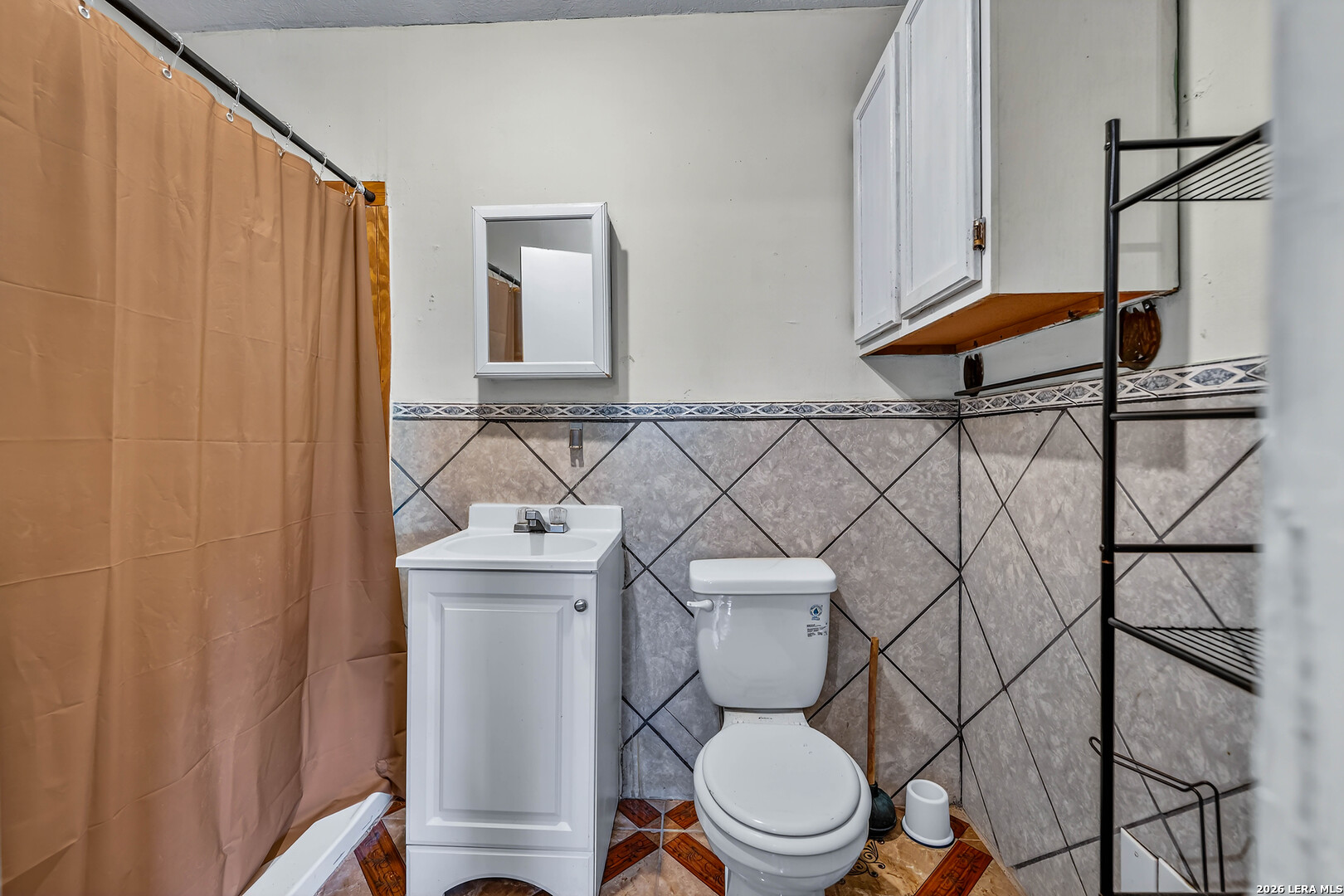 903 East Westmeyer Street Poth, TX 78147 - Photo 16 of 23 a white toilet sitting next to a bathroom sink