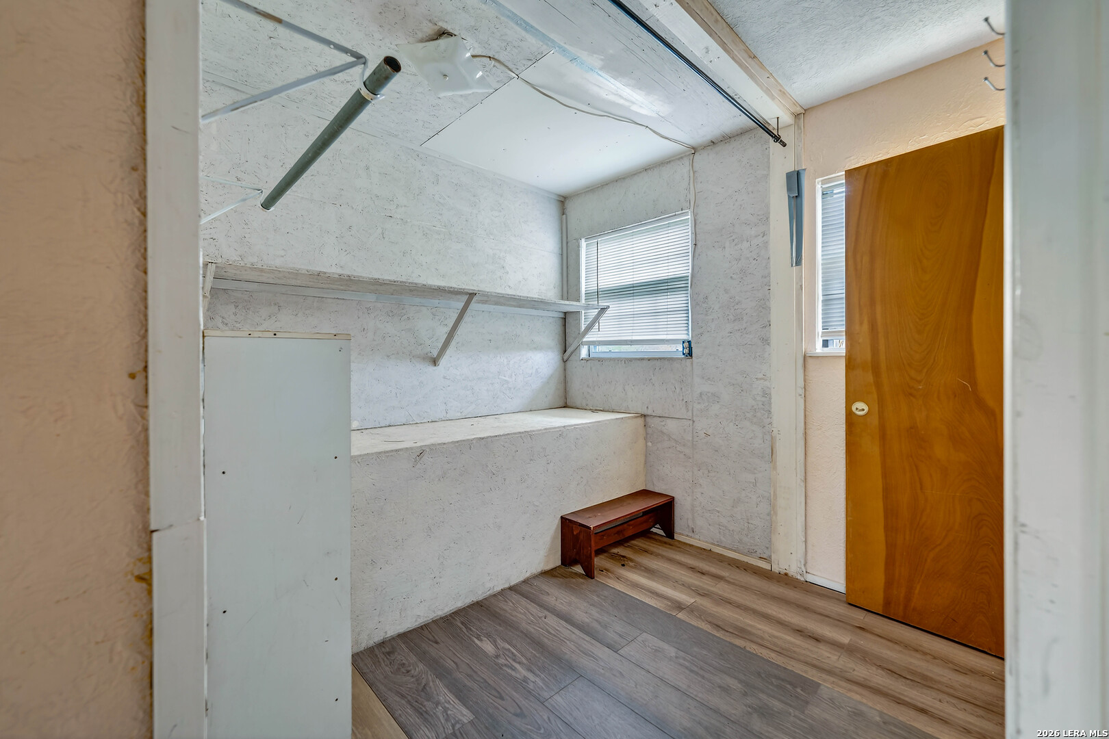 903 East Westmeyer Street Poth, TX 78147 - Photo 17 of 23 a view of an empty room with wooden floor and a window