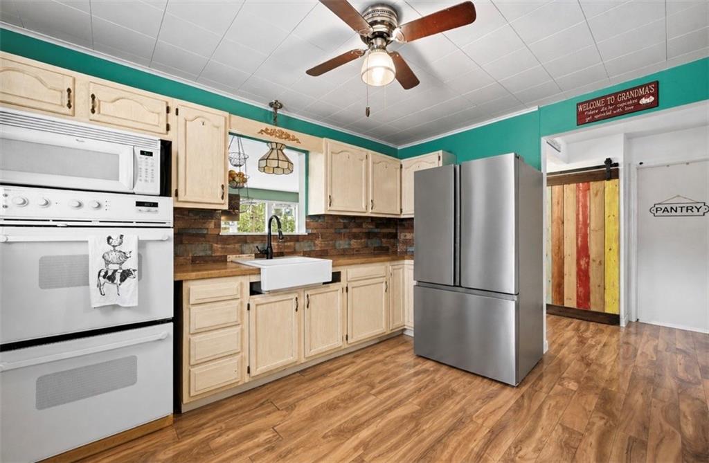 331 Hill Road Georgetown, PA 15043 - Photo 7 of 33 a kitchen with stainless steel appliances a refrigerator sink and cabinets