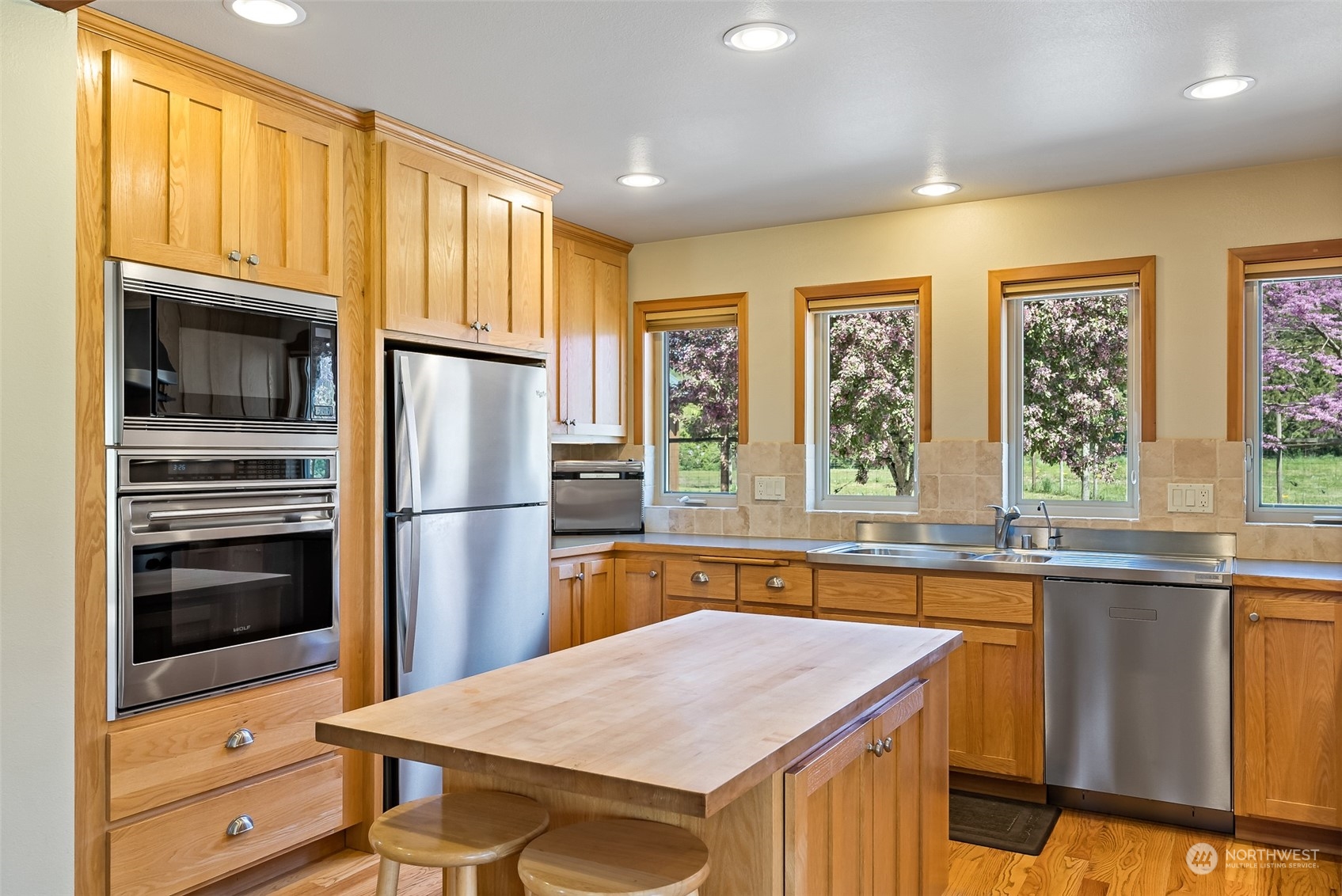 7901 Leibrant Road Everson, WA 98247 - Photo 7 of 39 a kitchen that has a kitchen island wooden cabinets and stainless steel appliances