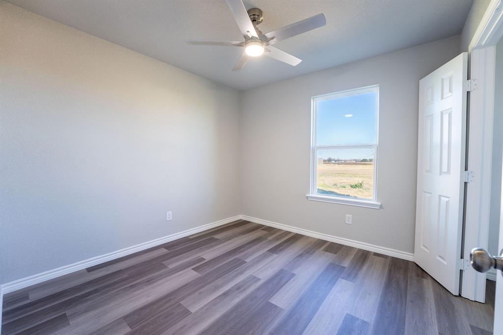 1020 Springview Lane Mabank, TX 75147 - Photo 11 of 15 Unfurnished room featuring dark wood-style flooring and ceiling fan