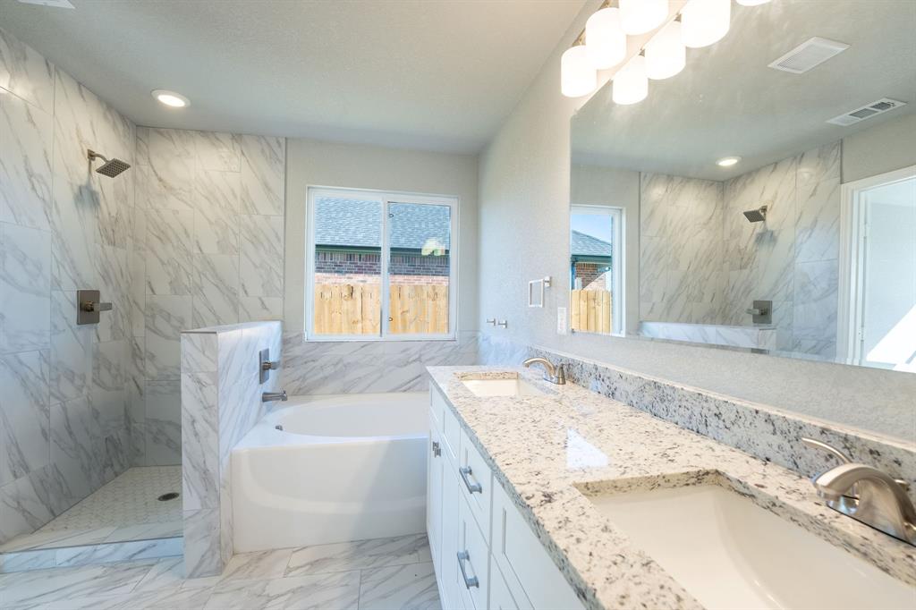 1020 Springview Lane Mabank, TX 75147 - Photo 7 of 15 Full bathroom with a marble finish shower, double vanity, a bath, recessed lighting, and light marble finish floors