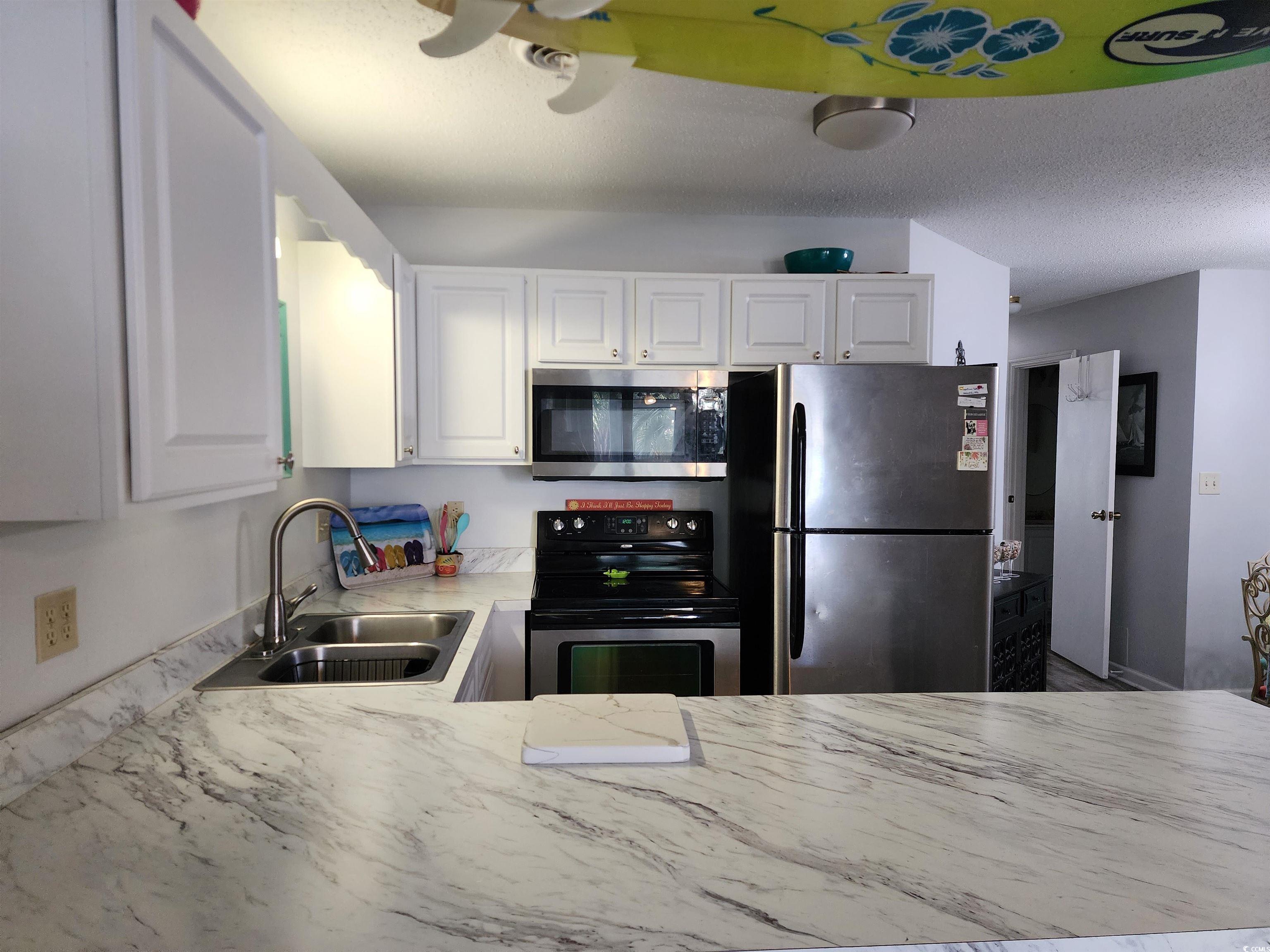 1870 Auburn Lane Surfside Beach, SC 29575 - Photo 6 of 18 Kitchen with sink, stainless steel appliances, a t