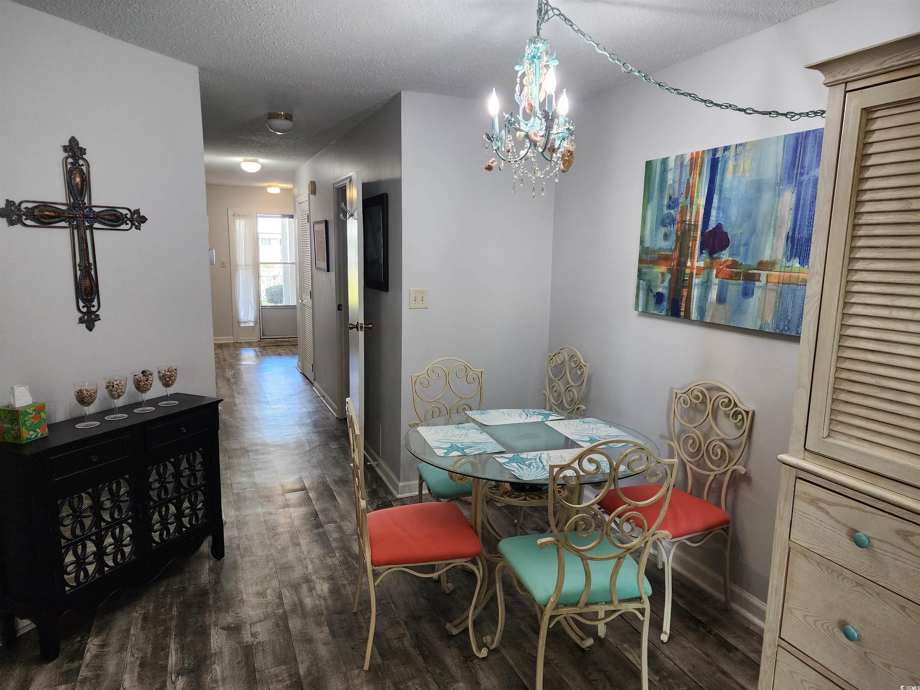1870 Auburn Lane Surfside Beach, SC 29575 - Photo 8 of 18 Dining room featuring a textured ceiling, dark har