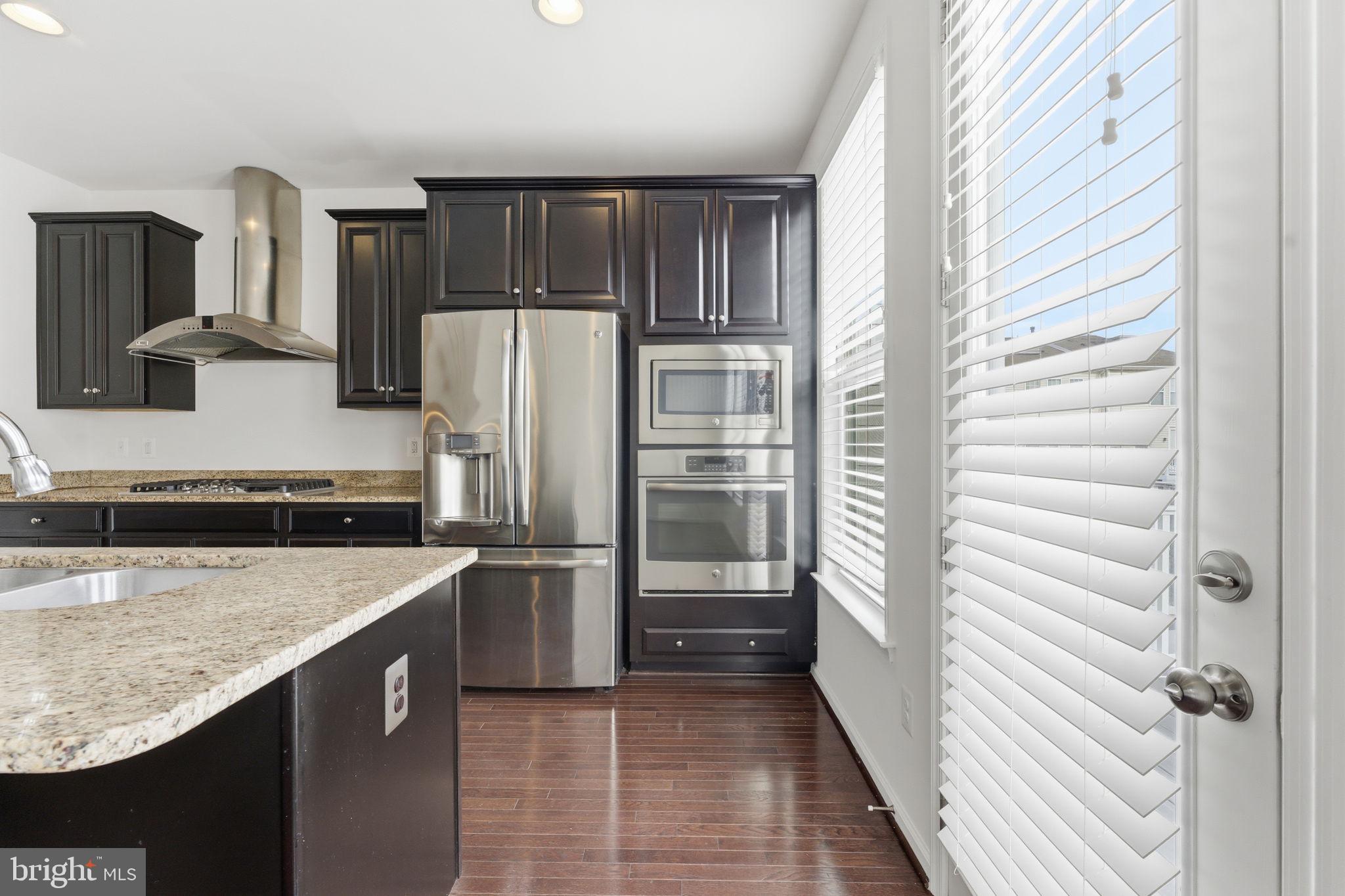 42396 Benfold Square Brambleton, VA 20148 - Photo 13 of 65 a kitchen with a refrigerator and a sink