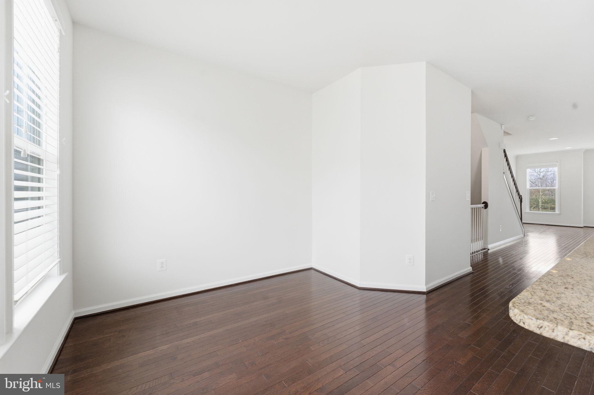 42396 Benfold Square Brambleton, VA 20148 - Photo 15 of 65 an empty room with wooden floor and windows