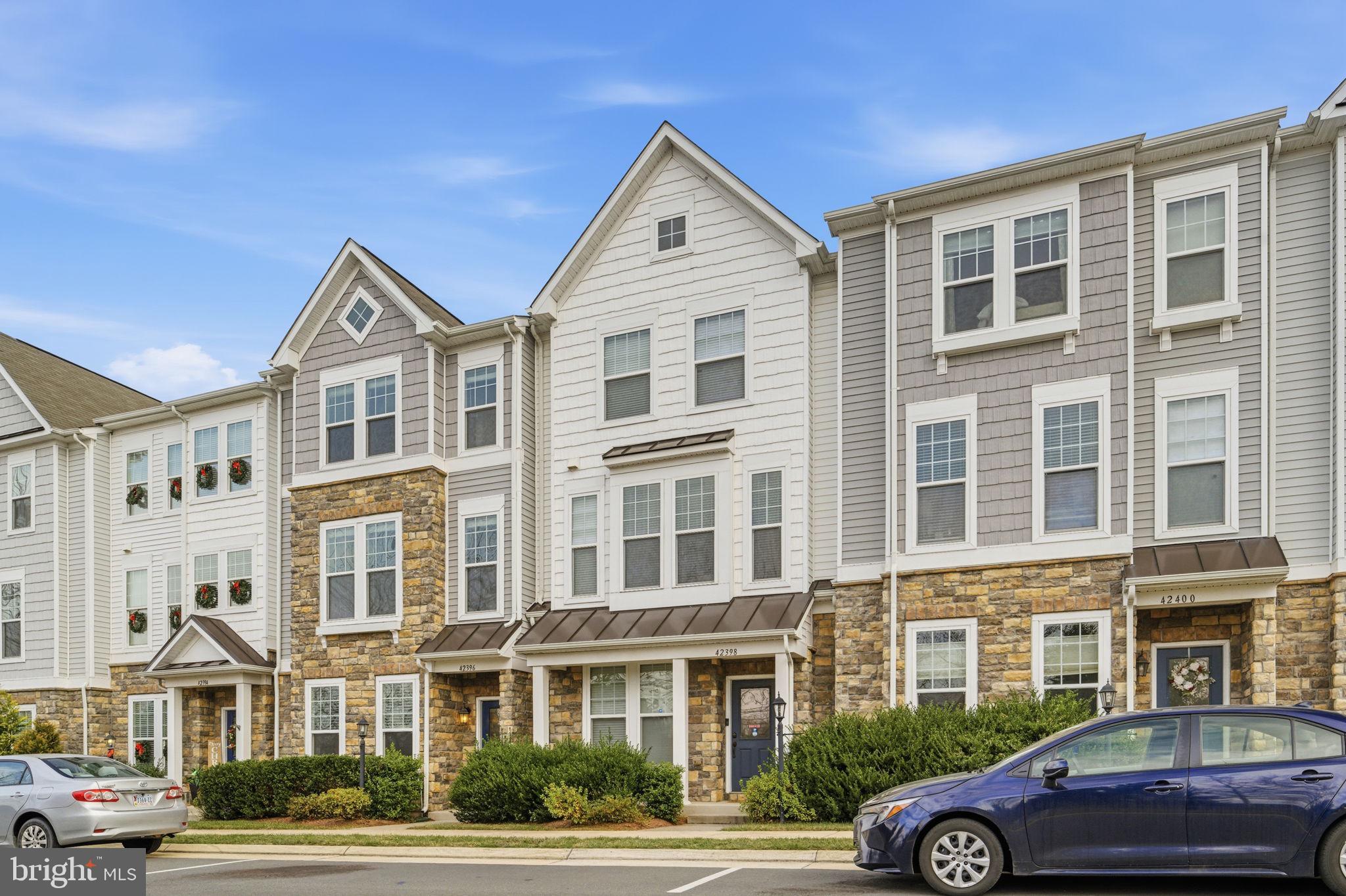 42396 Benfold Square Brambleton, VA 20148 - Photo 2 of 65 a front view of a building with parking space