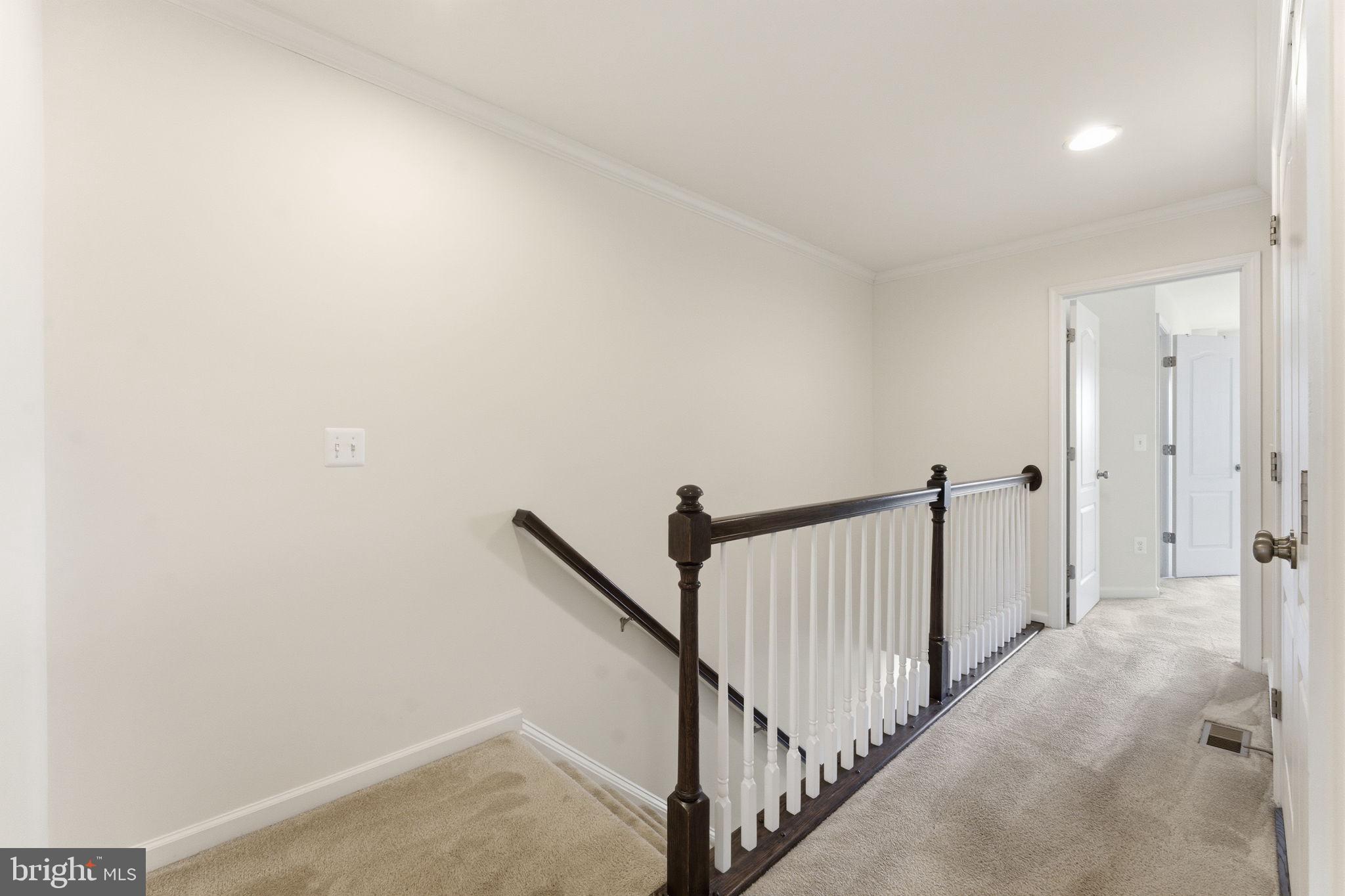 42396 Benfold Square Brambleton, VA 20148 - Photo 23 of 65 a view of a hallway with a white walls
