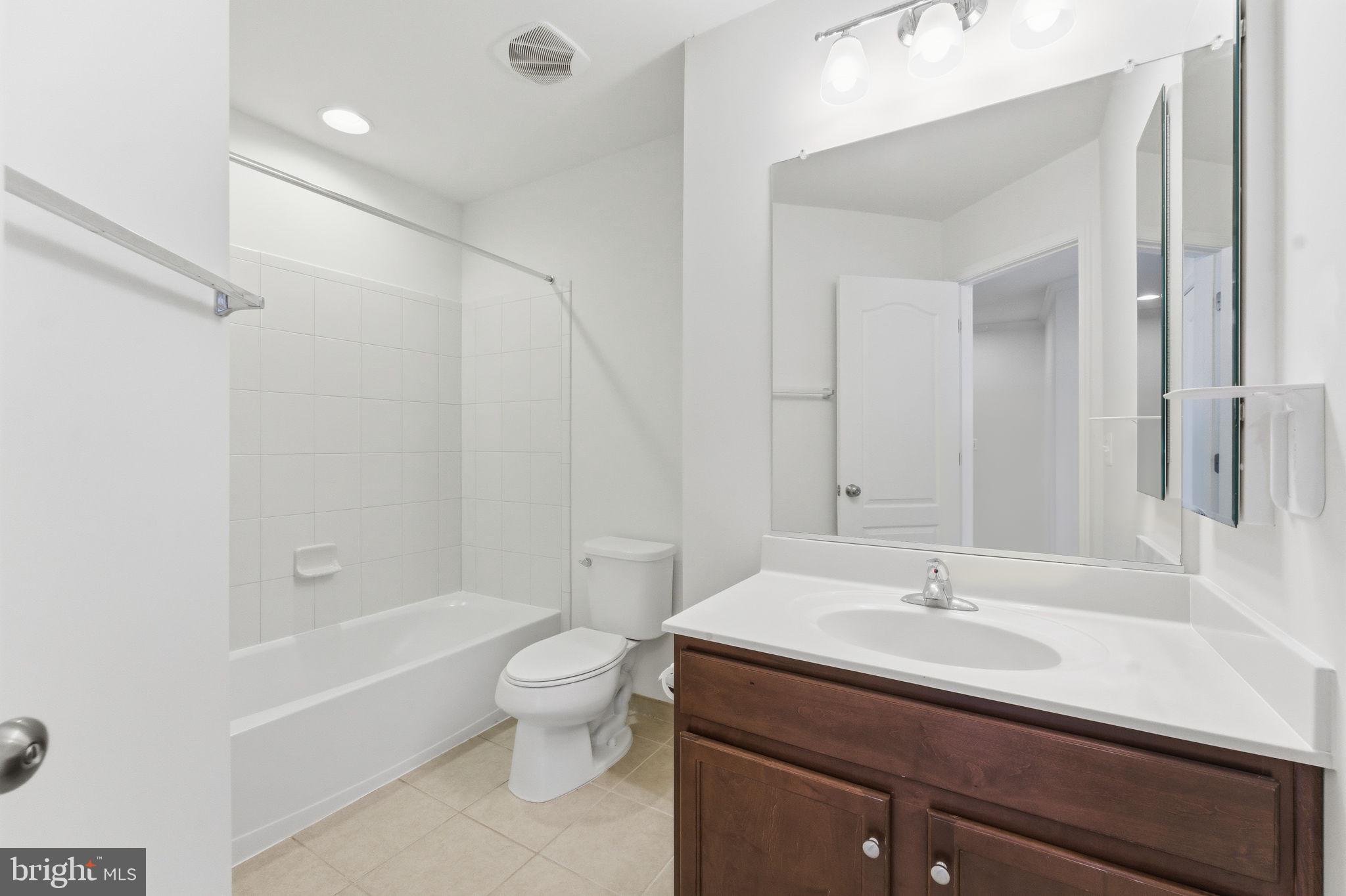 42396 Benfold Square Brambleton, VA 20148 - Photo 37 of 65 a bathroom with a sink a toilet and shower