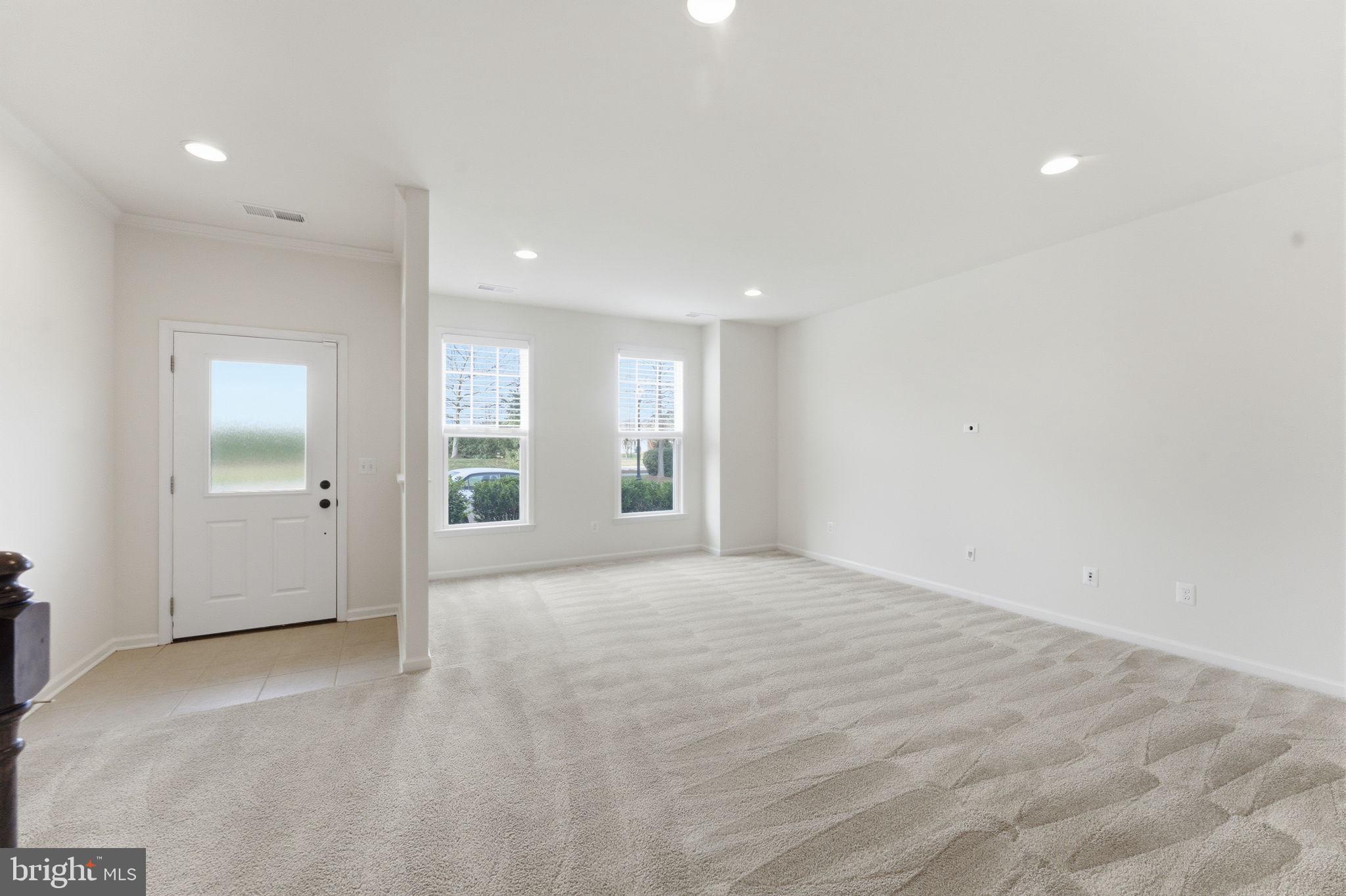 42396 Benfold Square Brambleton, VA 20148 - Photo 4 of 65 a view of an empty room with window and cabinet