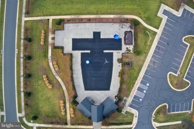 a view of an empty room with wooden floor and staircase
