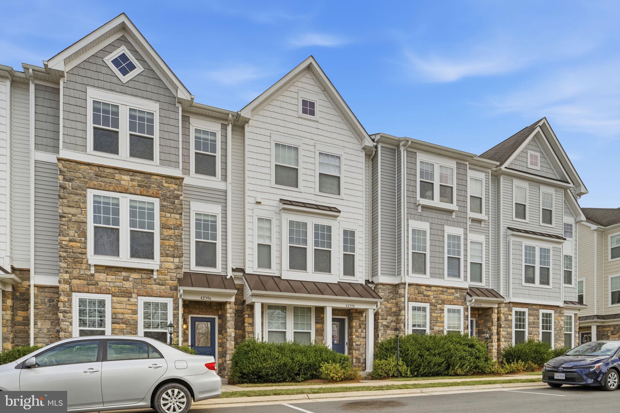 42396 Benfold Square Brambleton, VA 20148 - Photo 48 of 65 a front view of a building with parking space