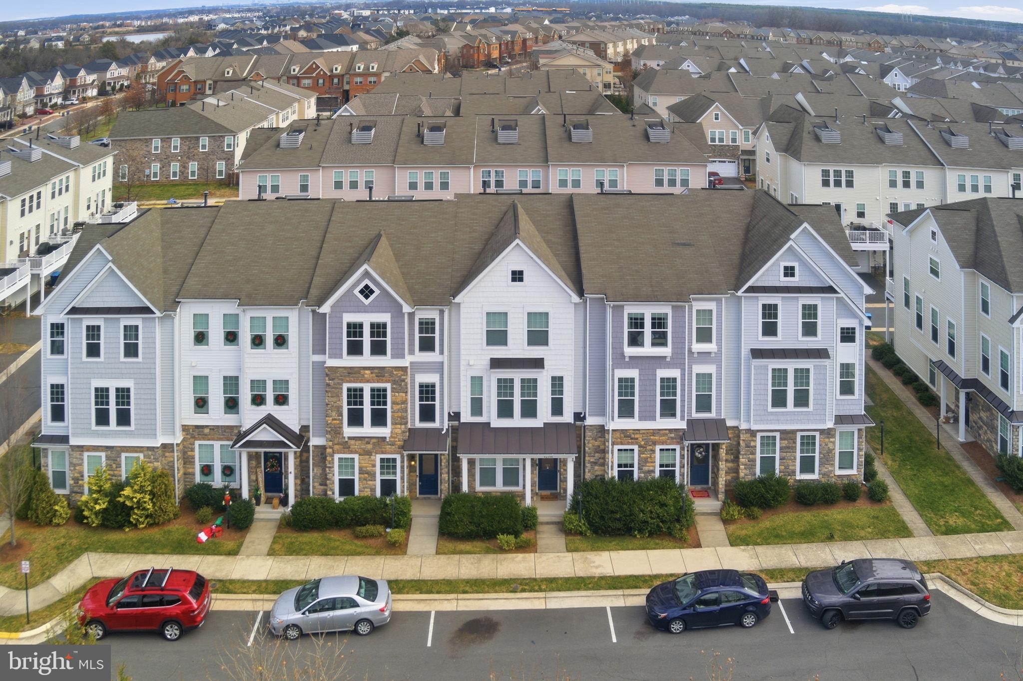 42396 Benfold Square Brambleton, VA 20148 - Photo 52 of 65 a front view of residential houses with street
