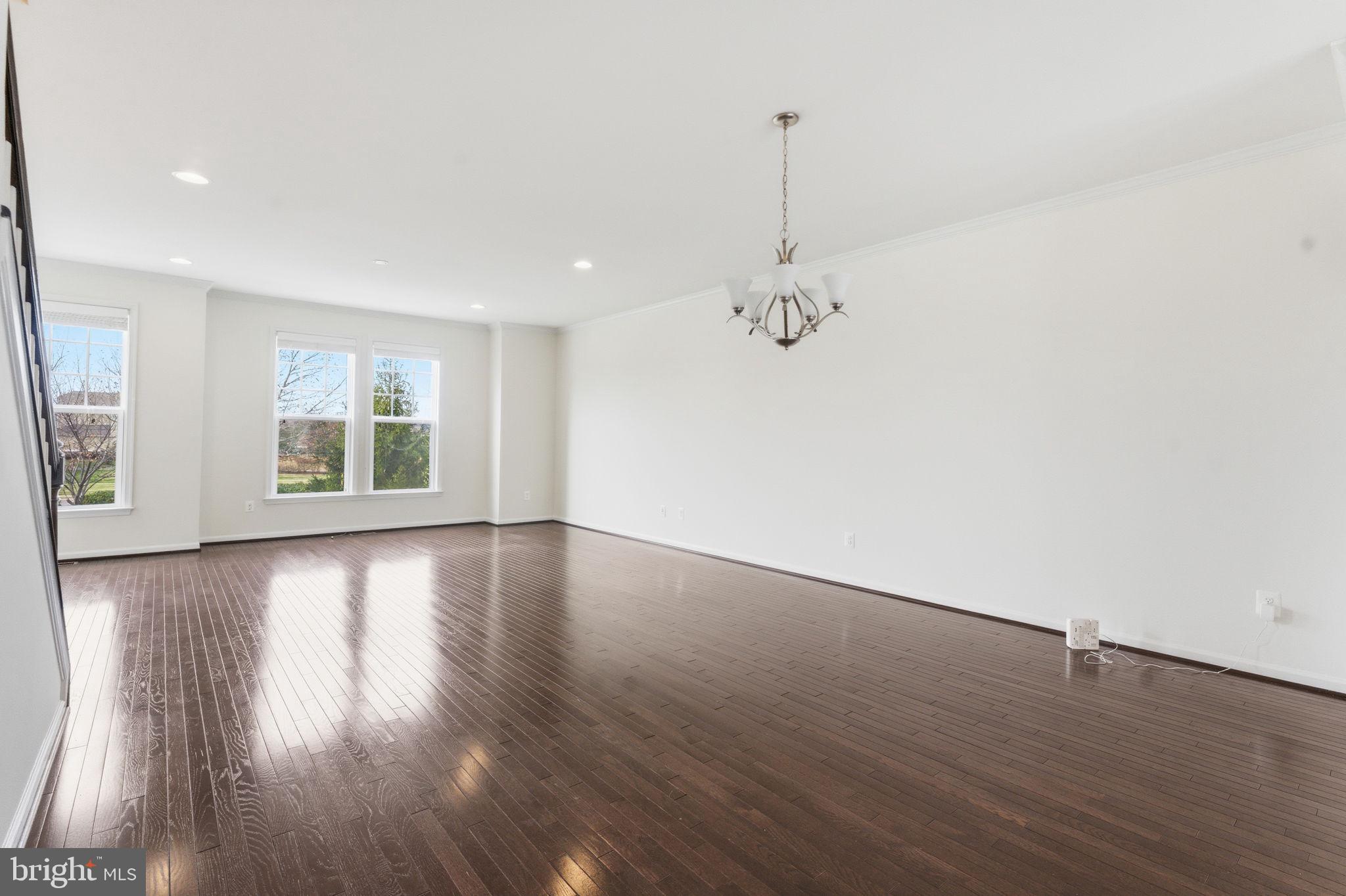 42396 Benfold Square Brambleton, VA 20148 - Photo 60 of 65 a view of an empty room with wooden floor and a window