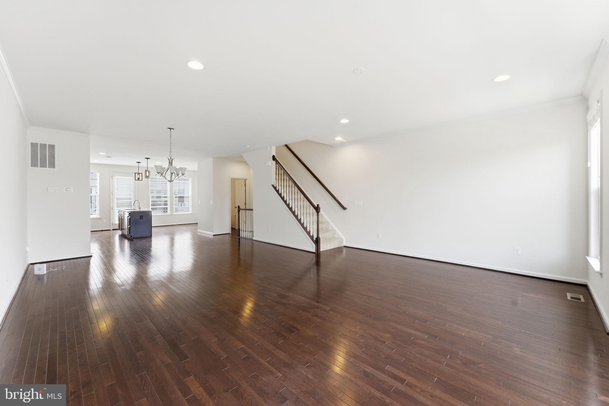 42396 Benfold Square Brambleton, VA 20148 - Photo 61 of 65 a view of an empty room with wooden floor and staircase